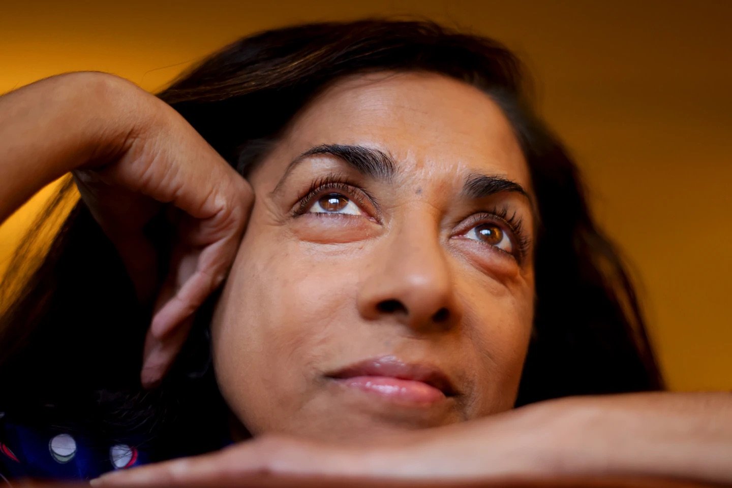 Close-up photo of VISIONS participant Nisha Falcigno looking up at the camera.